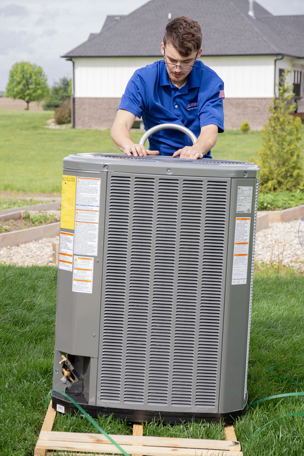 Johnson technician installing a new HVAC unit in Greenwood