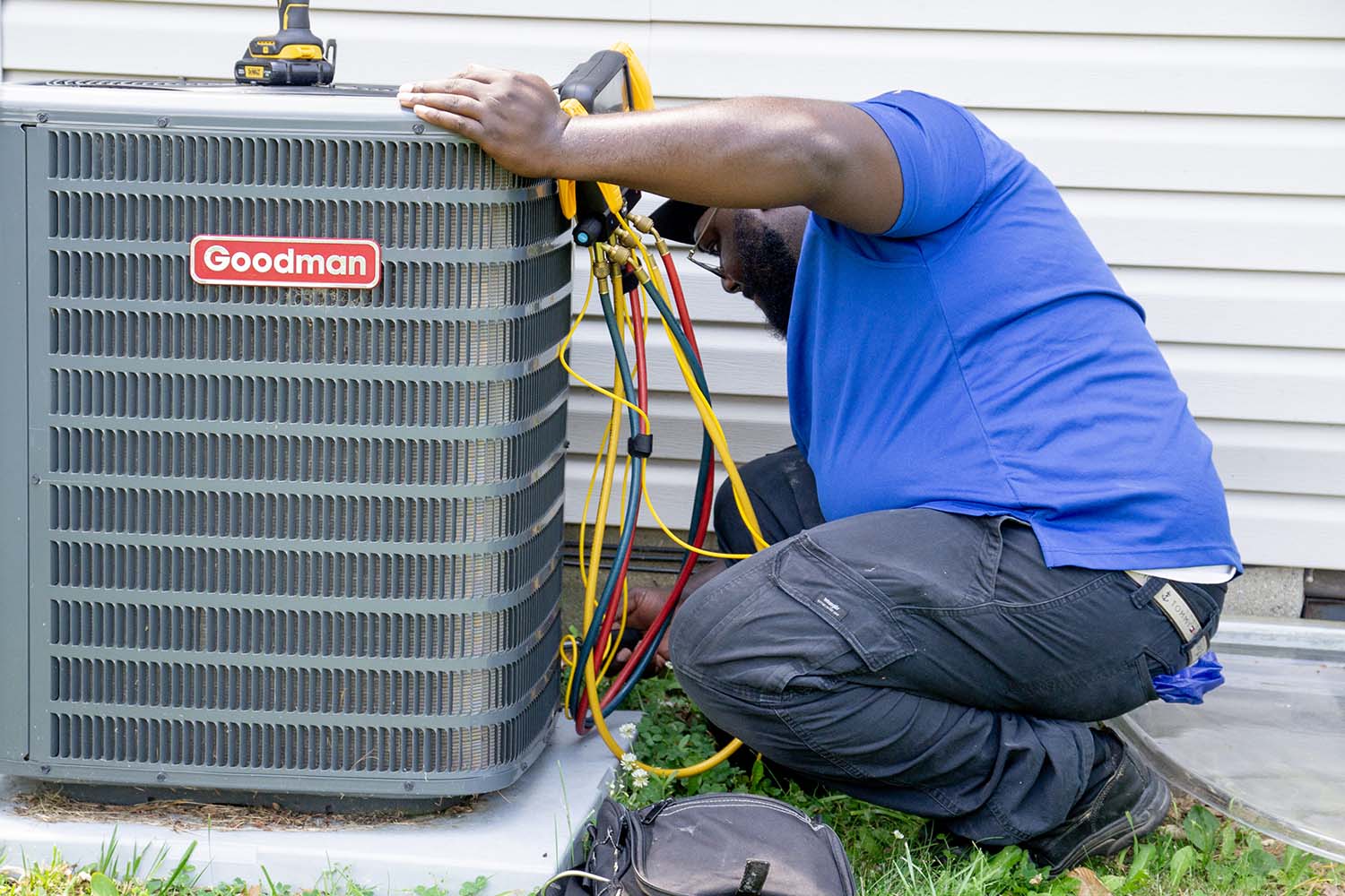 Thumbs up from Johnson HVAC technician working on an AC unit in Columbus
