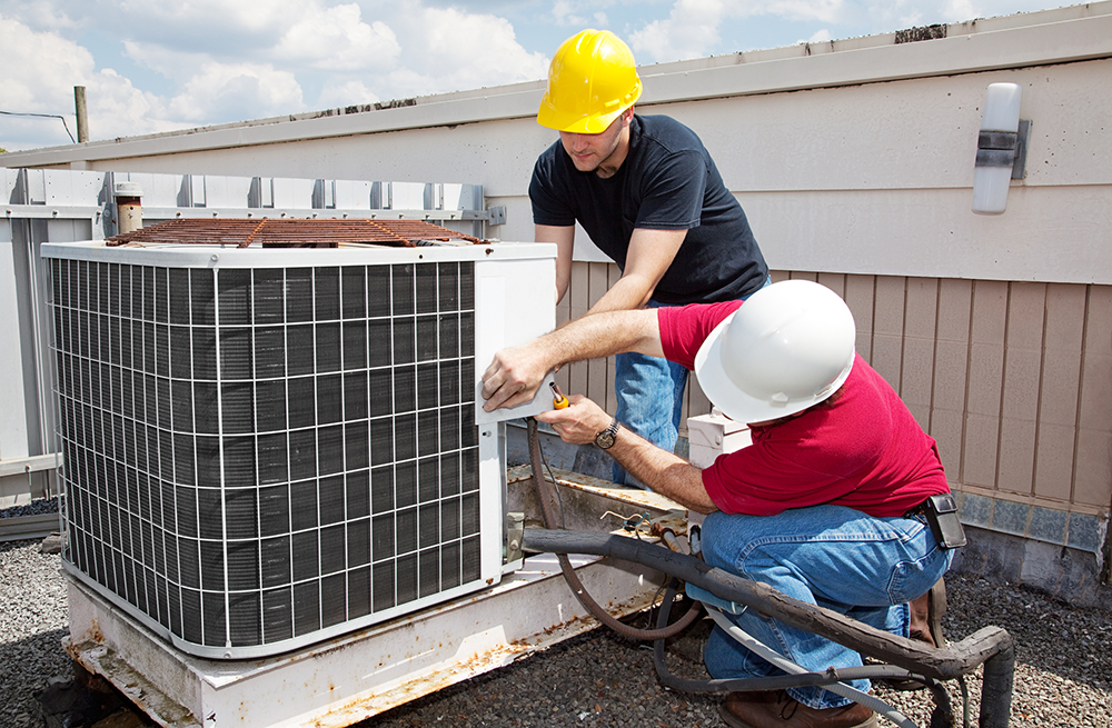 Men Fixing Commercial AC Unit Men Fixing Commercial AC Unit