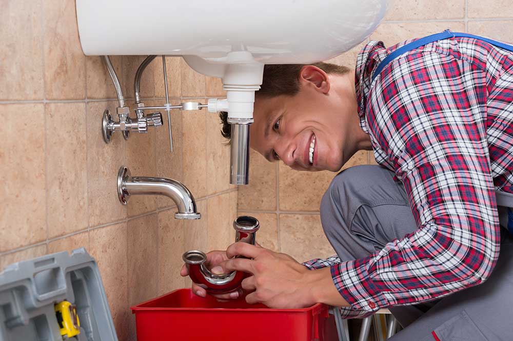 plumber fixing sink drain