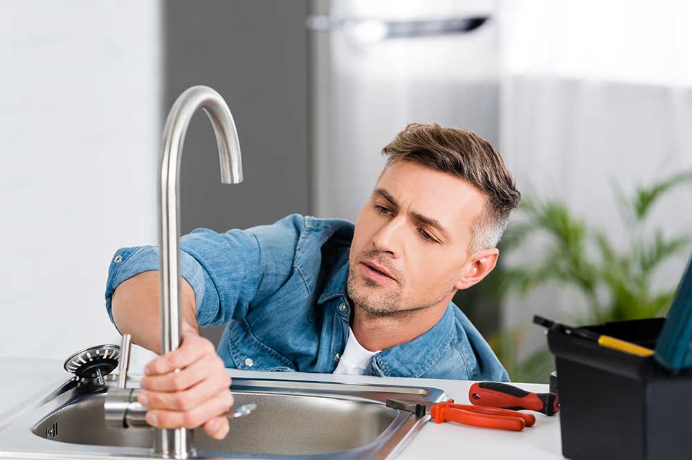 plumber installing a new faucet